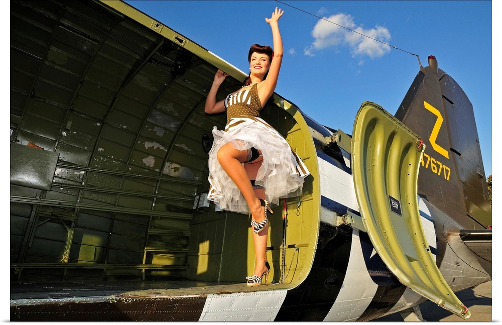 Sexy 1940's style pin-up girl standing inside of a World War II C-47 Skytrain aircraft.