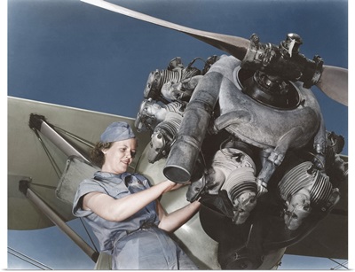 A 20 year old woman and expert aviation mechanic rebuilding an airplane engine.