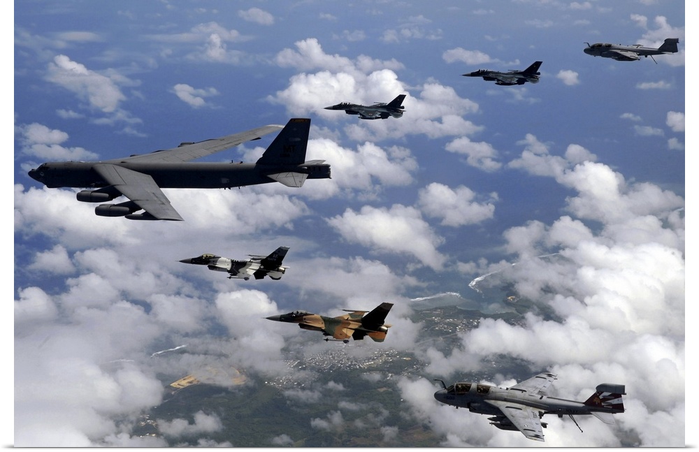 Military aircrafts are photographed flying high and in formation over Guam.