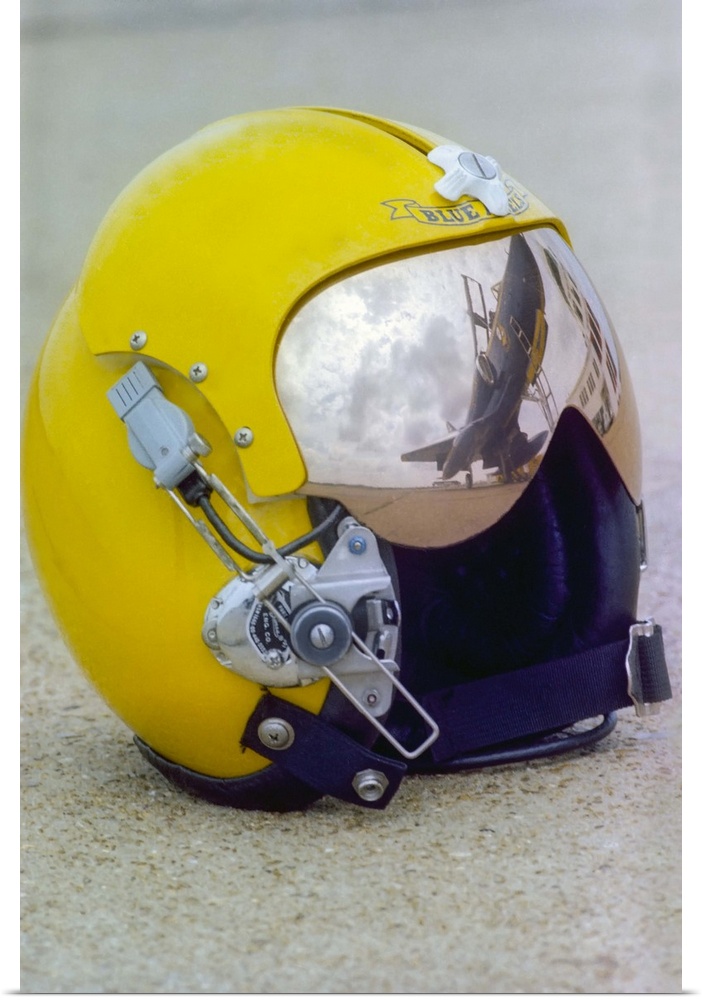 A Blue Angels pilot helmet with aircraft reflection in visor.