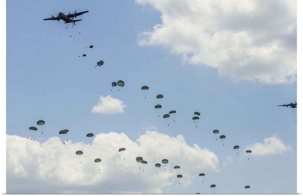 U.S. Air Force C-130 Hercules drop U.S. Army airborne troops over Andrews Air Force Base, Maryland.