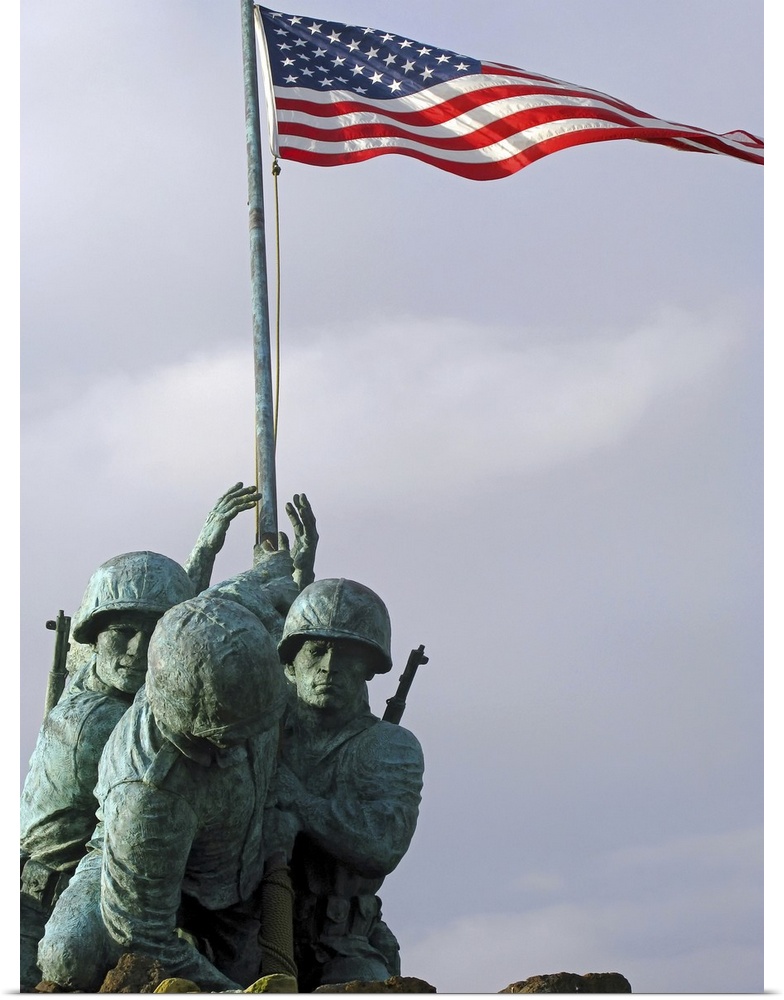 Up-close photograph of monument of soldiers lifting the American flag.