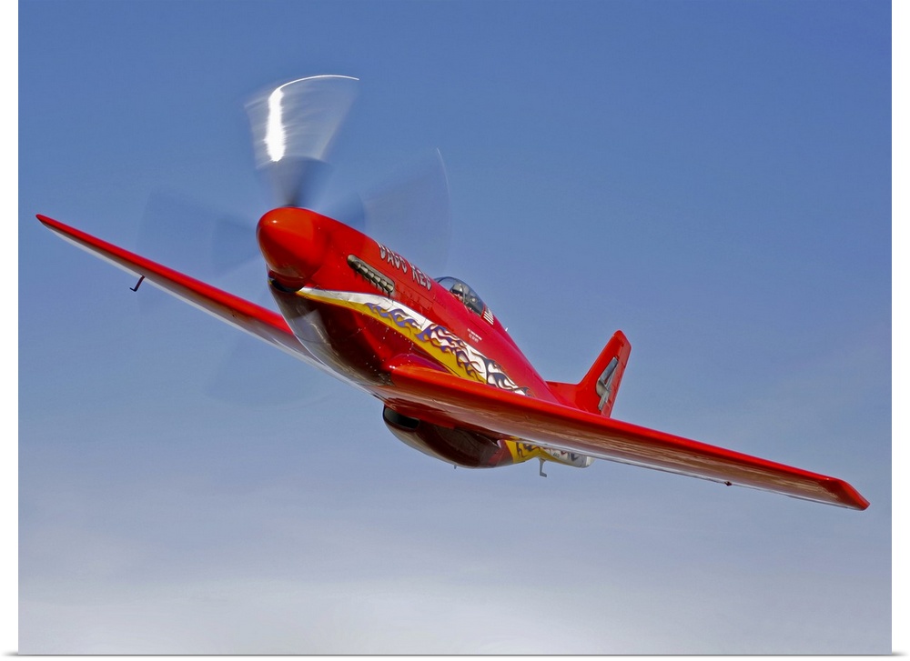 A Dago Red P-51G Mustang modified for competitive air racing, in flight over Hollister, California.