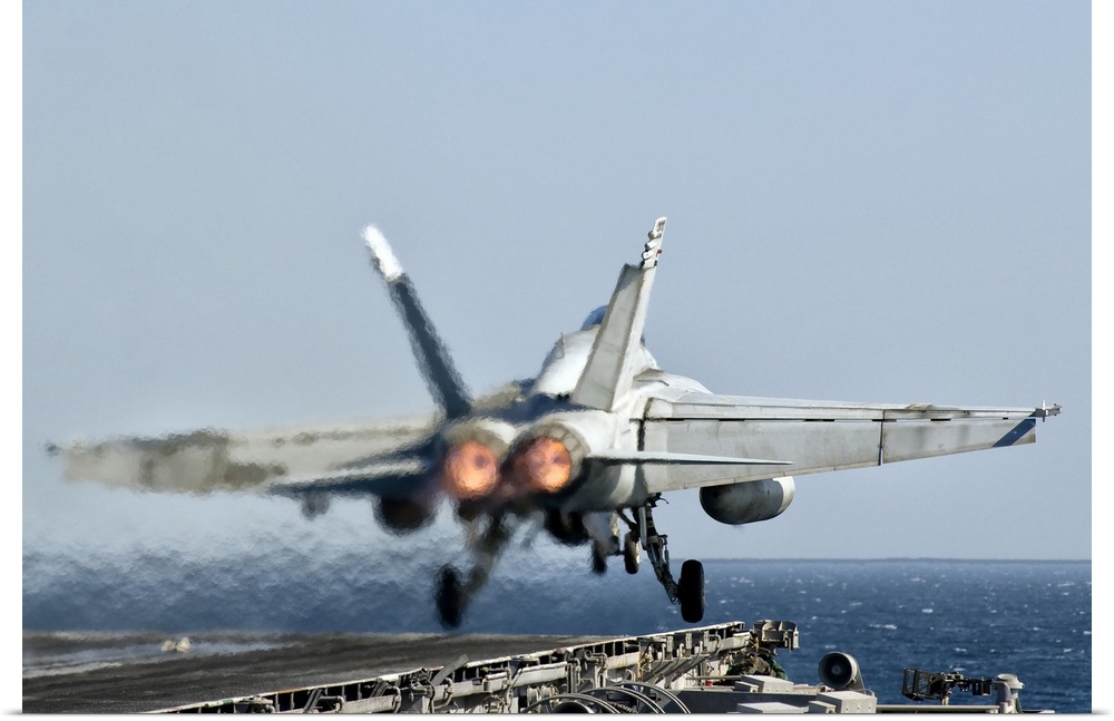 A US Navy F/A-18F Super Hornet launches from the flight deck of aircraft carrier USS Nimitz.