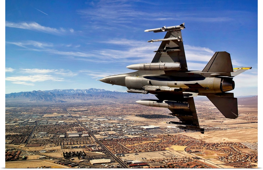 A fighter jet breaks right on a final approach over northern Las Vegas during day three of Red Flag 12-2, at Nellis Air Fo...