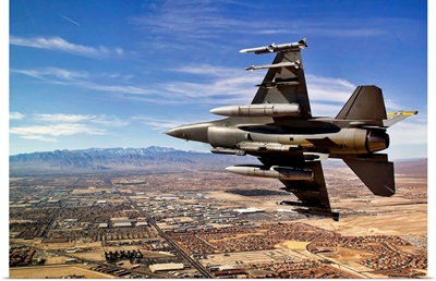 A fighter jet breaks right on a final approach over northern Las Vegas, Nevada