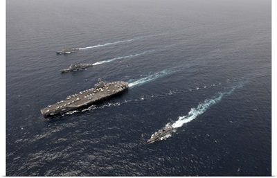 A formation of ships traveling at sea