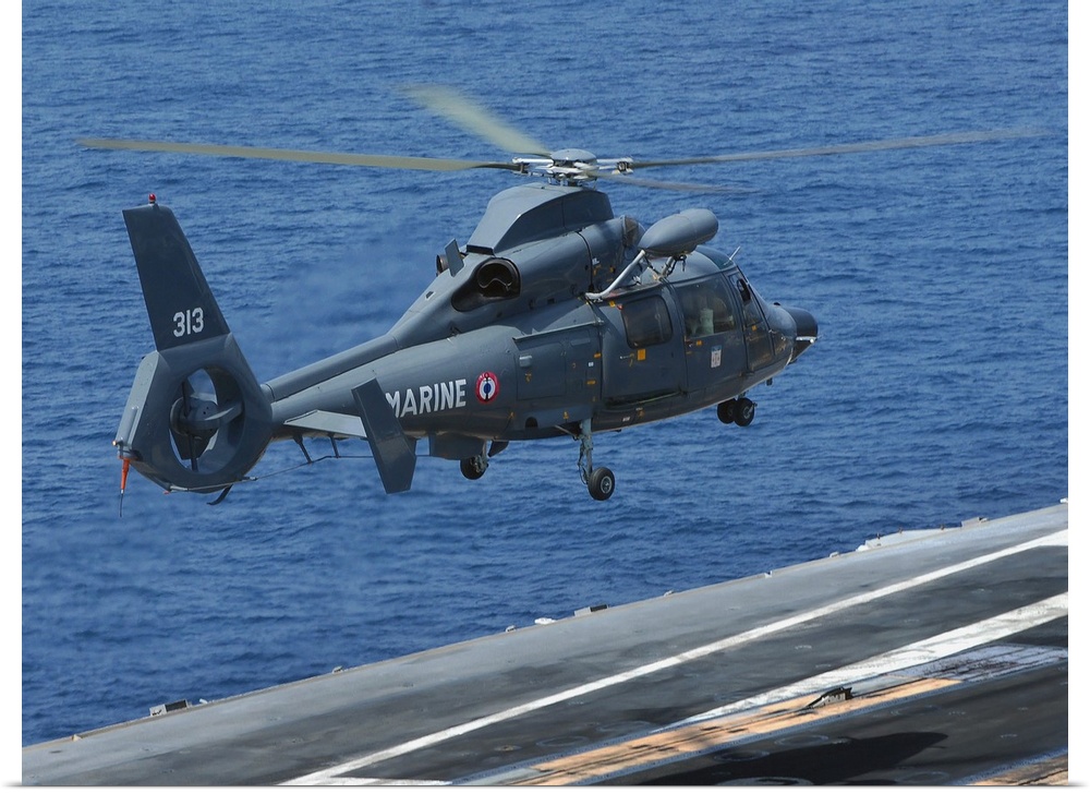 A French Dolphin 35F helicopter takes off from the flight deck of USS John C. Stennis.