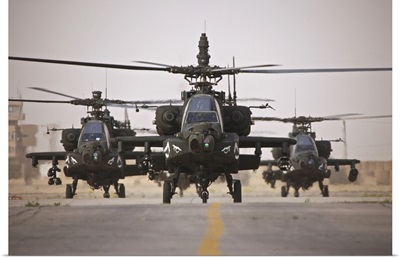 A group of AH-64D Apache helicopters on the runway at COB Speicher