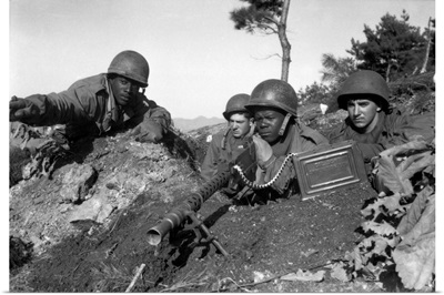 A machine gun crew in firing position during the Korean War