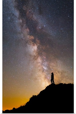 A man on a mountain under the Milky Way on the Lago-Naki plateau in Russia