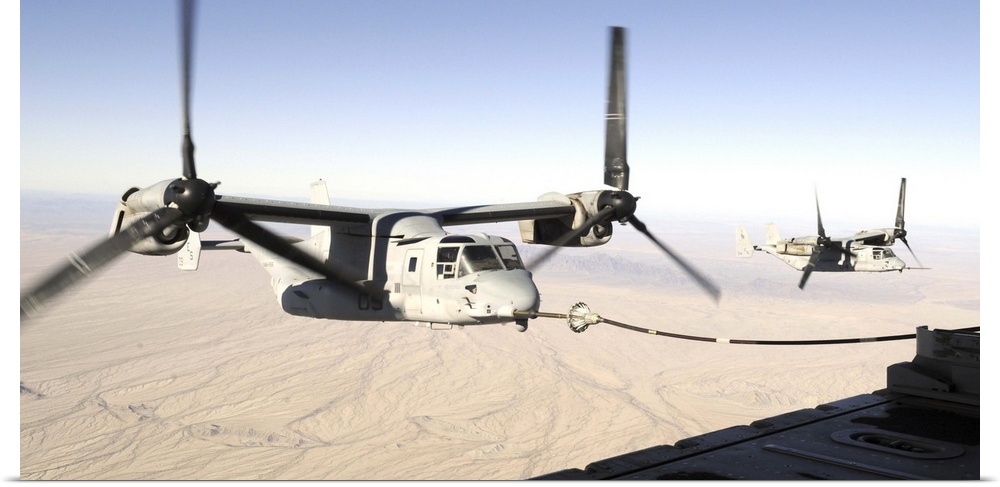 A MV22 Osprey refuels midflight while another waits its turn