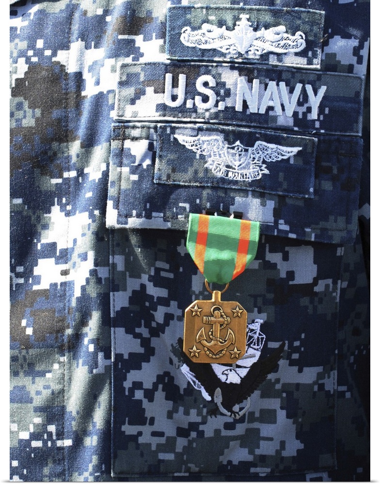 A Navy and Marine Corps Achievement Medal adorns the U.S. Navy uniform.
