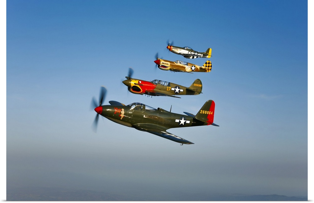 A Bell P-63 Kingcobra, two Curtiss P-40N Warhawk, and a North American P-51D Mustang in flight near Chino, California.