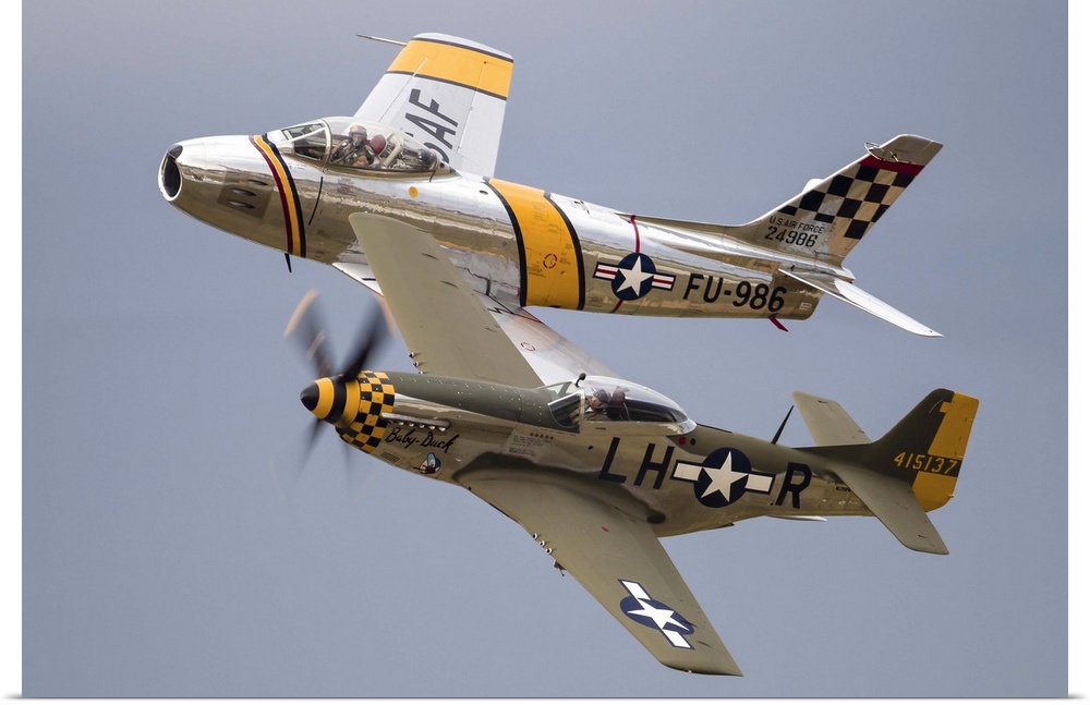 A P-51 Mustang and F-86 Sabre of the Warbird Heritage Foundation carry out a heritage pass at Waukegan, Illinois.