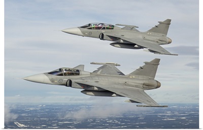 A Pair Of Swedish Air Force JAS-39 Gripen Fighter Jets In Flight Over Northern Sweden