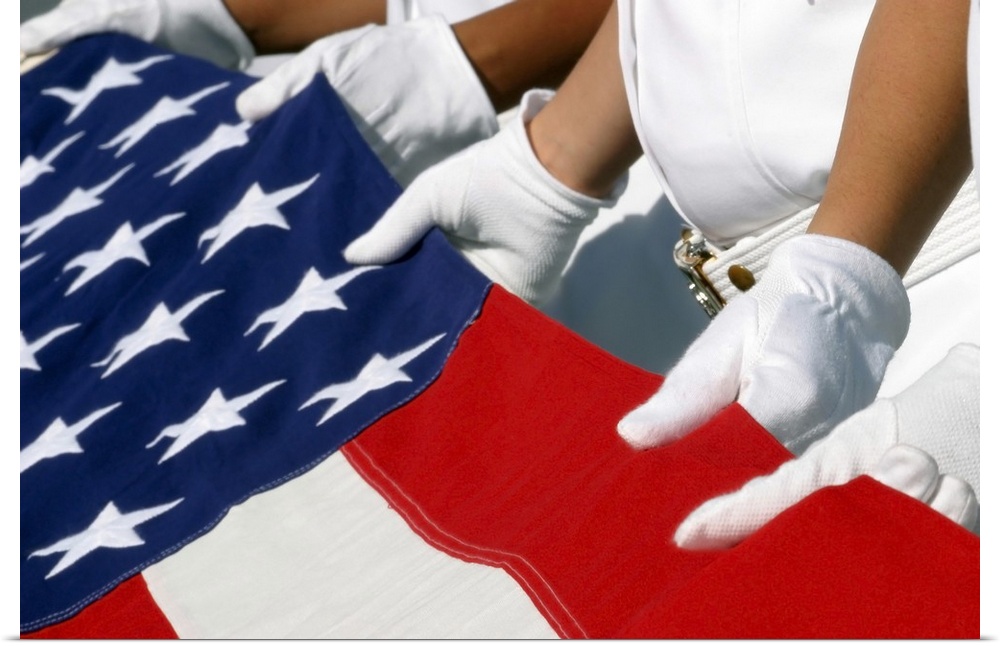 A Naval Station Pearl Harbor Ceremonial Guard folds the National Ensign during a burial ceremony.