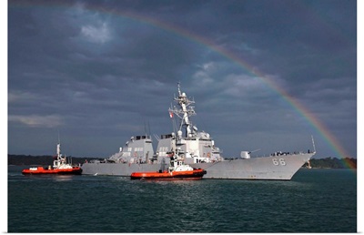 A rainbow arches over the guided missile destroyer USS Gonzalez