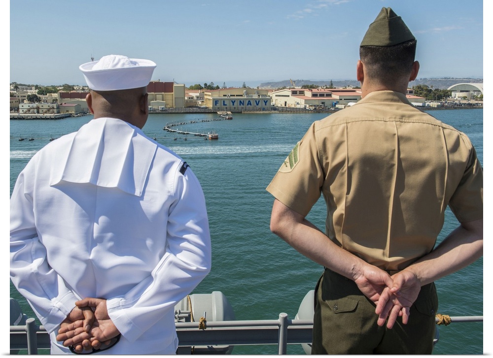 San Diego, California, August 23, 2013 - A Sailor and Marine man the rails aboard the amphibious assault ship USS Boxer (L...