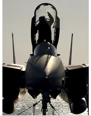 A Sailor cleans the canopy of a F-14B Tomcat