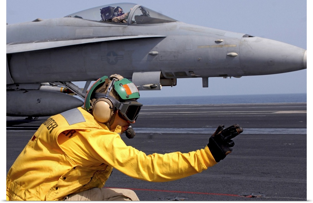 North Arabian Sea, September 1, 2008 - A shooter gives the signal to launch an F/A-18C Hornet assigned to the Stingers on ...