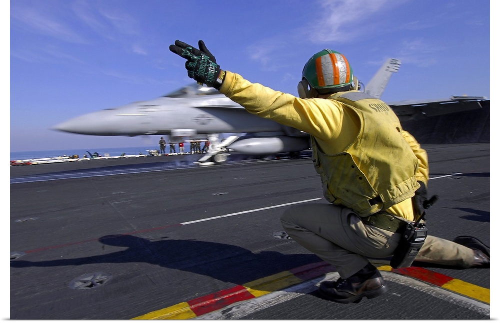 Persian Gulf, February 7, 2008 - A shooter on the flight deck of the Nimitz-class aircraft carrier USS Harry S. Truman, gi...