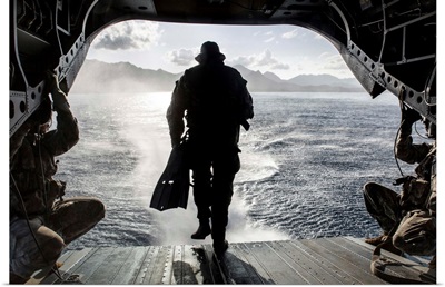 A soldier conducts a combat dive mission off the back of a CH-47 Chinook