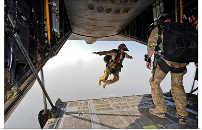 A U.S. Air Force pararescueman jumps out of an HC-130P Combat King aircraft