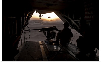 A U.S. Marine provides aerial security from a CH-53E Super Stallion