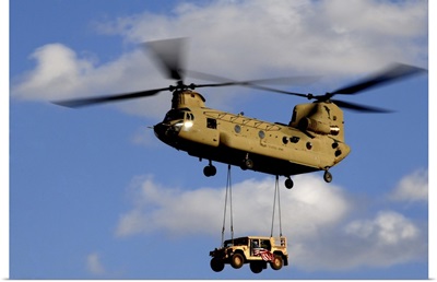 A US Army CH-47 Chinook Helicopter Transports A Humvee