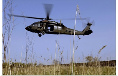 A US Army UH60 Black Hawk helicopter prepares to pick up soldiers