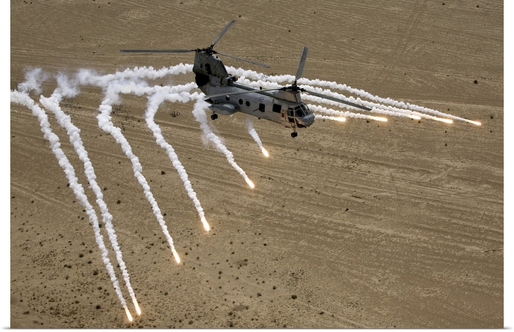 February 24, 2008 - A U.S. Marine Corps CH-46 Sea Knight helicopter launches flares as it flies over the desert near Al Ta...