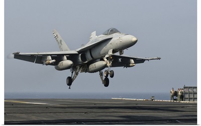 A US Navy F/A-18C Hornet prepares to land aboard USS Eisenhower