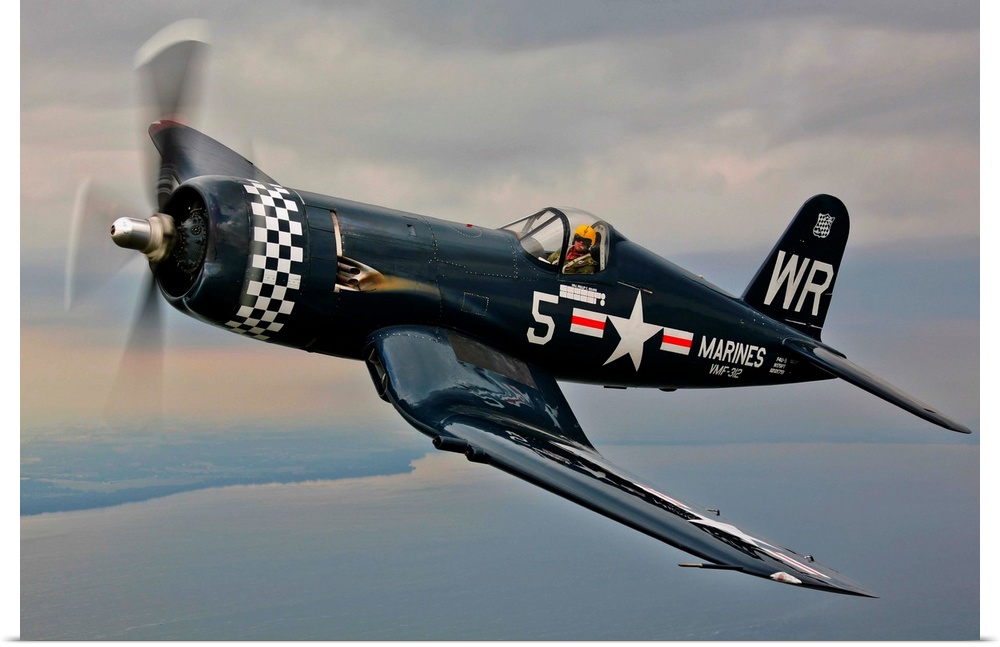 A Vought F4U-5 Corsair in VMF-312 markings during the Korean War, flying over Oshkosh, Wisconsin.