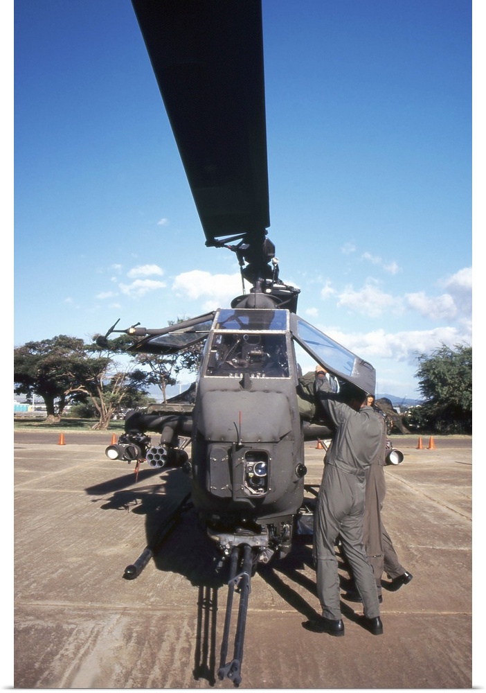 Air crewmen secure an AH1 Cobra attack helicopter