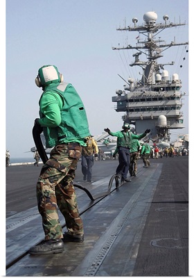Air Department crewmembers remove slot seal from a catapult aboard USS George Washinton