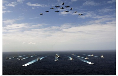 Aircraft fly over a group of US and Japanese Maritime Self-Defense Force ships