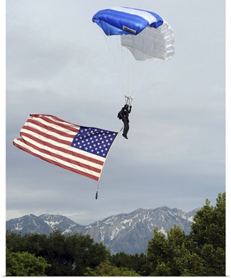 Airman floats through the sky carrying the American flag