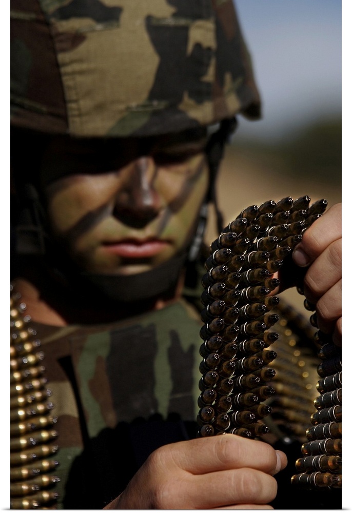 Fort Huachuca, Arizona - Airman loads up ammunition for the M-249 automatic rifle prior to a tactics exercise.