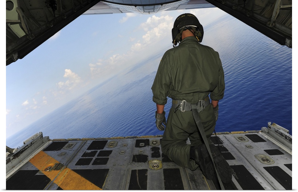 St. Petersburg, Florida, May 29, 2010 - Airman observes the waters of the Gulf of Mexico from a C-130 Hercules. The C-130 ...