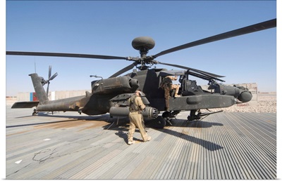 Airmen board an Apache helicopter at Camp Bastion, Afghanistan
