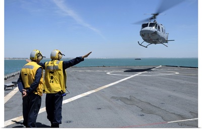Airmen Direct A Spanish Navy AB-212 Helicopter Onto The Flight Deck Of USS Gunston Hall