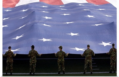 Airmen present the American Flag during the National Anthem