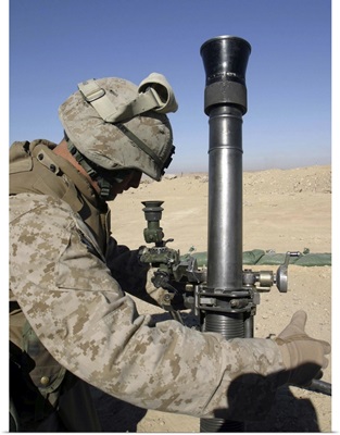 An 81mm mortarman adjusts the mortar sights during a fire mission