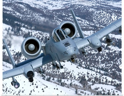 An A-10C Thunderbolt flies over the snowy Idaho countryside