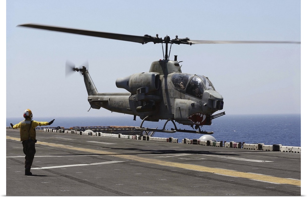 Red Sea, July 23, 2013 - An AH-1W Super Cobra helicopter takes off from the flight deck of the amphibious assault ship USS...