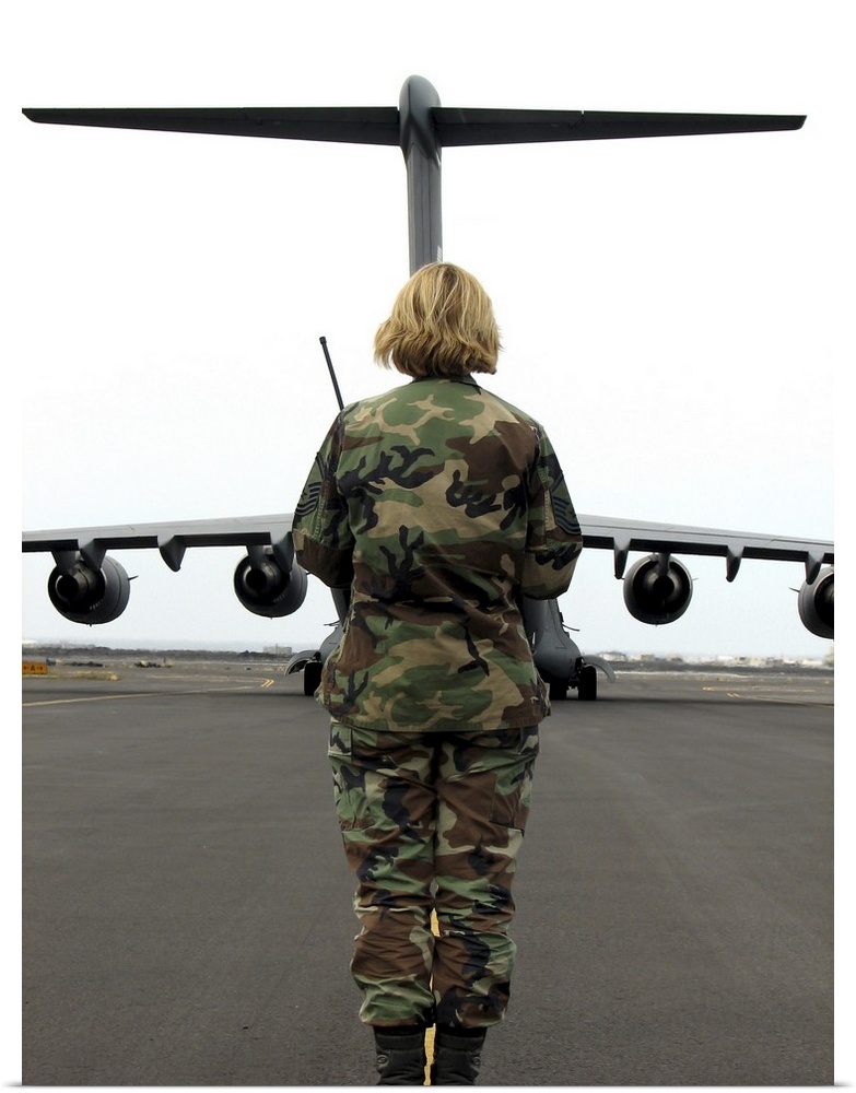 An airfield manager greets an arriving C-17 Globemaster III.