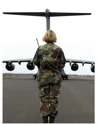 An airfield manager greets an arriving C-17 Globemaster III