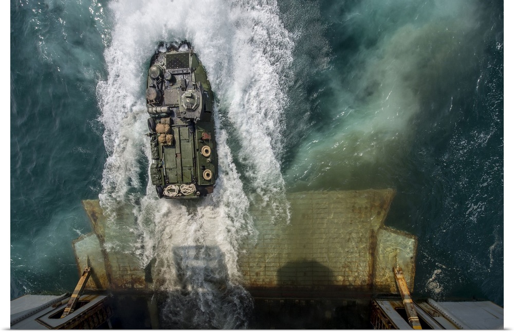 Arabian Gulf, August 24, 2014 - Marines aboard an amphibious assault vehicle (AAV) exit the well deck of the amphibious as...