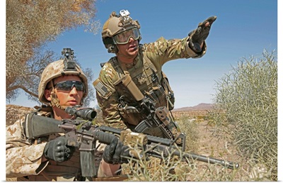 An Army soldier informs a Marine on the current situation while providing security